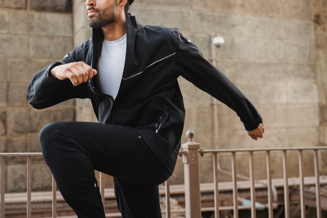 Windproof running jackets test — runner in shell jacket on exposed ridge in high wind