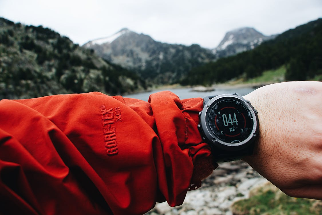 Running GPS watch for beginners — runner checking wrist watch in city park