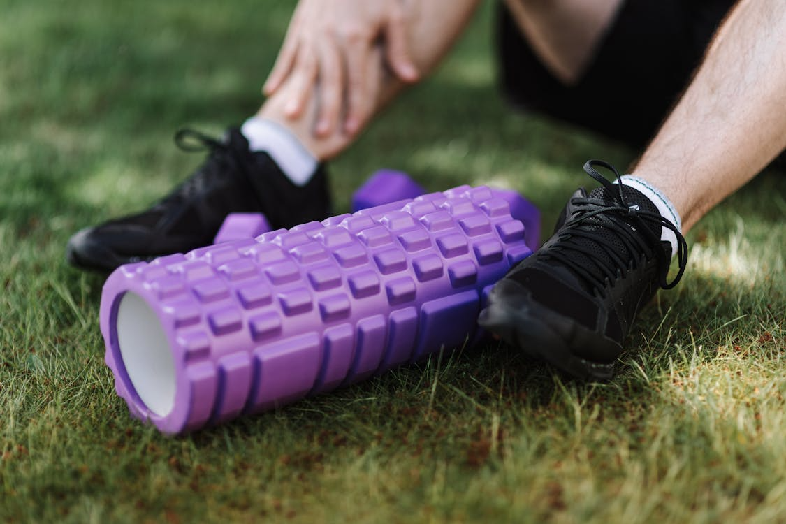 Best running recovery tool editors pick — foam roller on athlete legs night before race