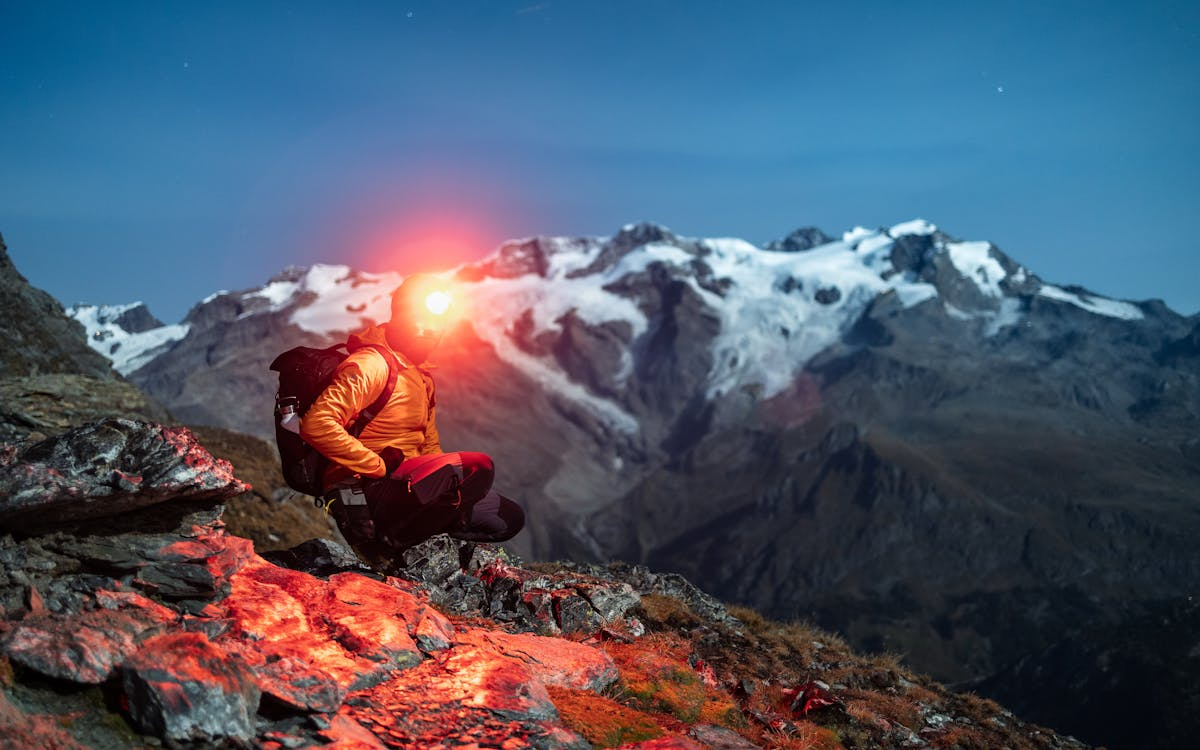 Trail running headlamp buying guide — headlamp beam on dark forest trail