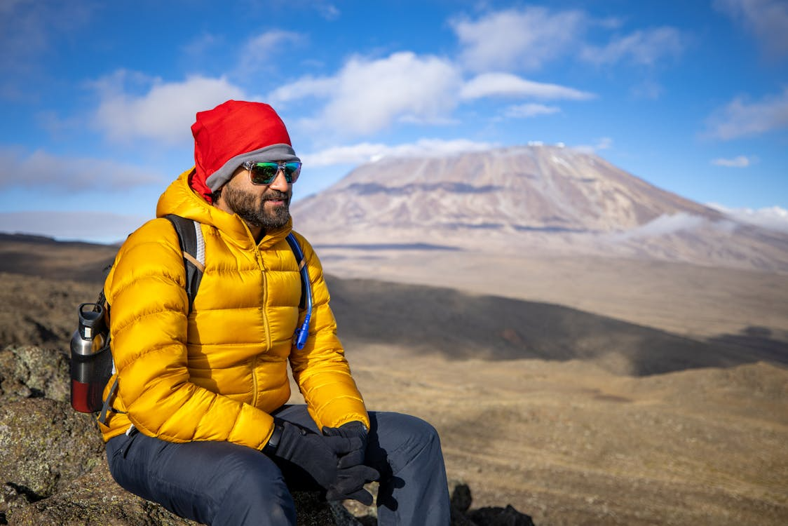 Down vs synthetic insulation jacket wet performance comparison on mountain trail