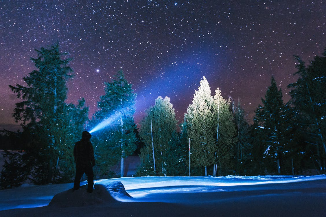 Best mountaineering headlamp editors pick — headlamp beam on alpine approach in darkness