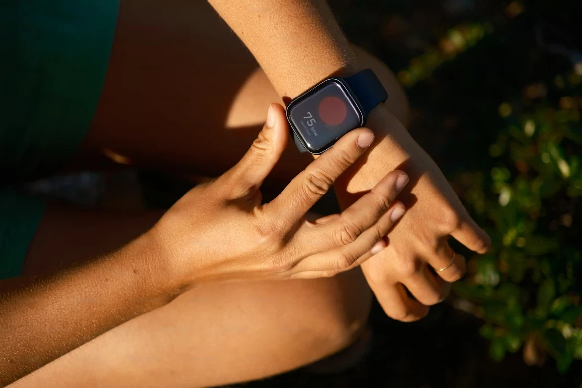 Heart rate monitor running guide — runner checking HR on watch during easy run