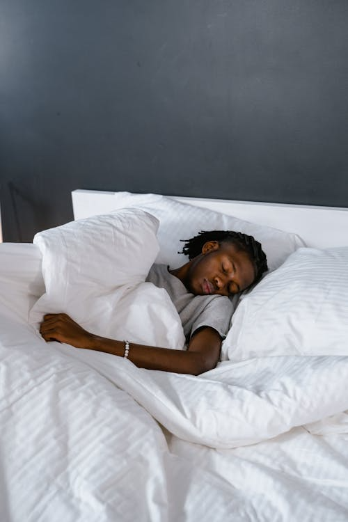 Sleep protocol marathon race week — runner sleeping with phone alarm on nightstand